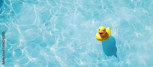 Bright yellow rubber duck floating in clear blue pool water with ample negative space for text or graphic design elements