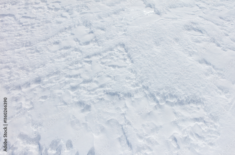 A snow covered ground with a white snowflake on it A snow covered ground with a white snowflake on it