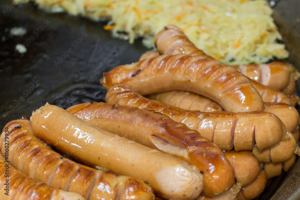 sausages are fried on a brazier for street food. sausages are fried on a brazier for street food.