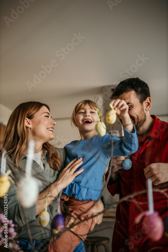 The family decorates eggs and enjoys quality time together. Easter preparations concept photo