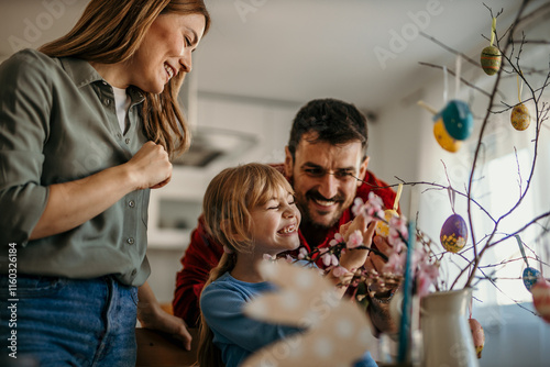 Photography Happy family gathered around the table painting colorful Easter eggs in their co