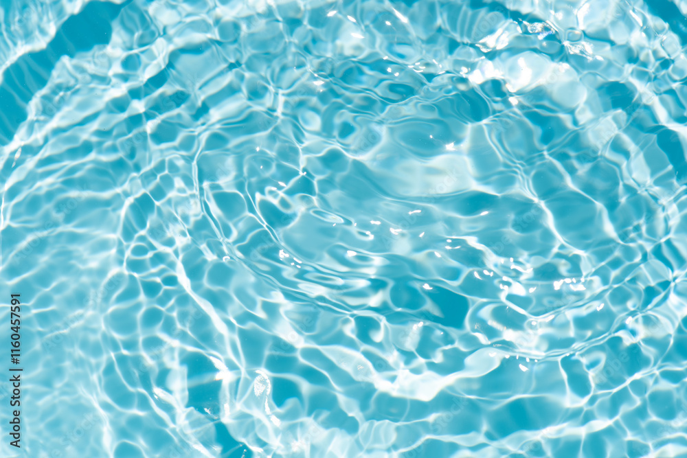 Obraz premium Blue water with ripples on the surface. Defocus blurred transparent blue colored clear calm water surface texture with splashes and bubbles. Water waves with shining pattern texture background.