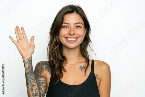 Friendly good-looking european woman entrepreneur with tattoo joyfully welcome you wave palm gladly invite greet person smiling broadly enthusiastic grin say hi hello stand white background photo