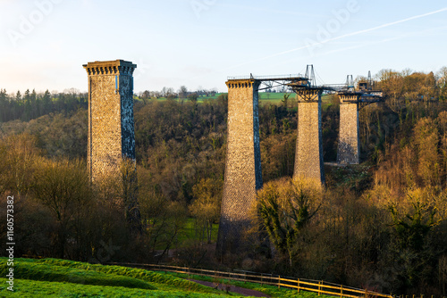 Viaduc de la Souleuvre, a disused railway bridge from the former Caen-Vire line, in winter with a sunset photo