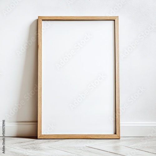 photograph of a simple, rectangular picture frame in the format 70 x 100 cm in front of a white wall, oak, narrow edge, the picture frame is empty