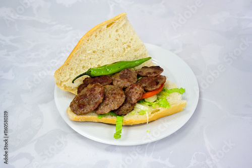 Meatball between bread (Turkish name : ekmek arasi kofte ) Izgara kofte. Manisa, Akcaabat, Akhisar  kofte. Delicious meat grilled meatballs. photo