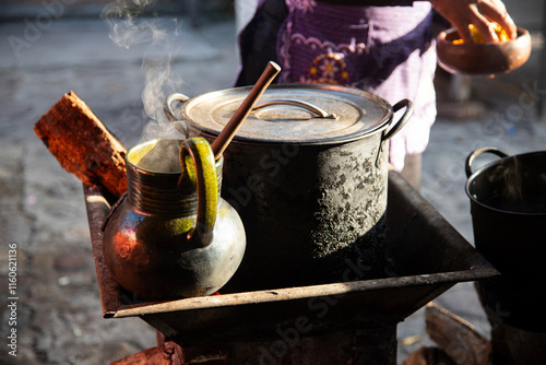 Clay and iron pots at a street food stand in Oaxaca cooking traditional Mexican cafe de olla. photo