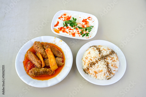 Very nice izmir patties, potatoes, tomatoes and Turkish spices. Eksili eksili Izmir sulu Kofte. Fellah, ekmek arasi izgara kofte.Izgara kofte. Manisa, Akcaabat, Akhisar kofte. photo