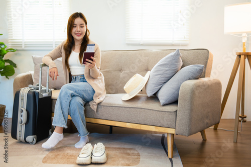 Travel preparation. Cheerful young asian woman packing suitcase, getting ready for vacation at home, copy space. Female going on tourist trip, happy about abroad adventure.