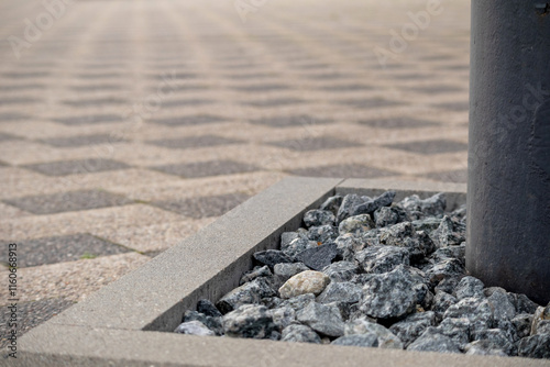 

A pavement of small gray concrete blocks arranged in a checkerboard pattern. The pavement is placed on the ground and small gaps are visible between the paving stones. photo