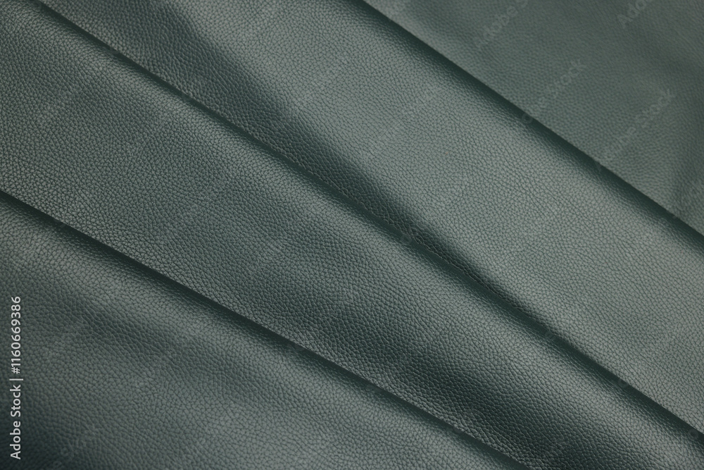 Fototapeta premium Leather texture: Elegant folds and shading A representation of high quality leather with visible wrinkles and shading that highlight the softness and structure of the material.