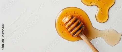 Wooden honey dipper on white surface with golden honey dripping to the left. Black seeds mixed in for a distinctive touch. No mention of light blue table. photo