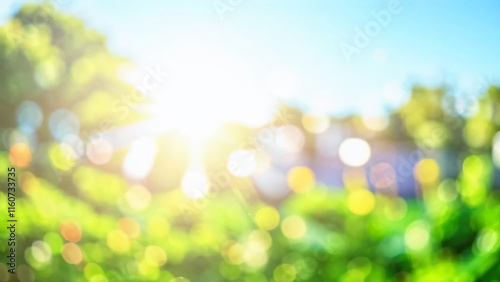 Blurred bokeh background of fresh green spring, summer foliage of tree leaves with blue sky and sun flare photo