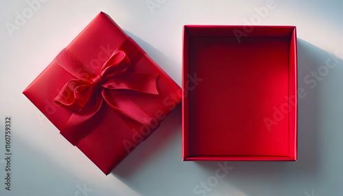 Empty open red gift box with red ribbon bow on white background, flat lay, top view, product placement