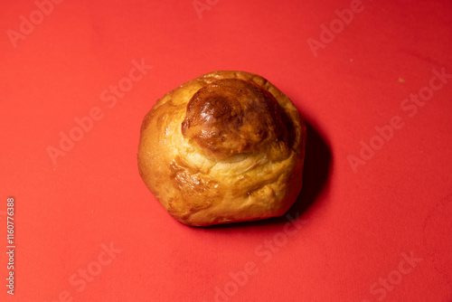 Wallpaper Mural Golden Brioche Roll on Vibrant Red Background Torontodigital.ca