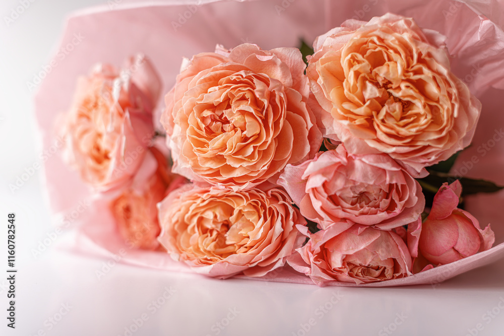 Close-up bouquet of airy roses on a white table.