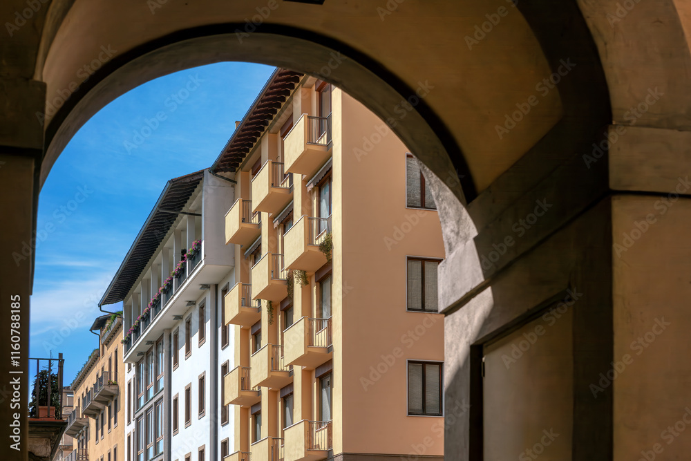 The charming streets of Florence, the unique stone buildings and architectural details under the bright blue sky, capturing the essence of Tuscany.