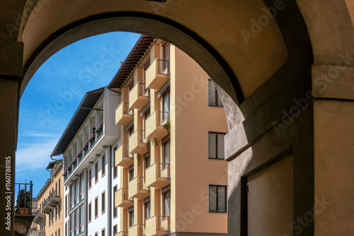 The charming streets of Florence, the unique stone buildings and architectural details under the bright blue sky, capturing the essence of Tuscany.