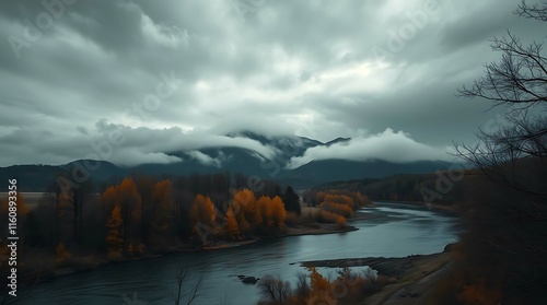 A tranquil, moody landscape featuring a river winding through a valley with colorful autumn foliage, under a dramatic sky filled with dramatic clouds and mist-shrouded mountains photo