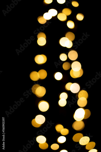 Golden blurred bokeh lights on black background. Christmas lights overlay.