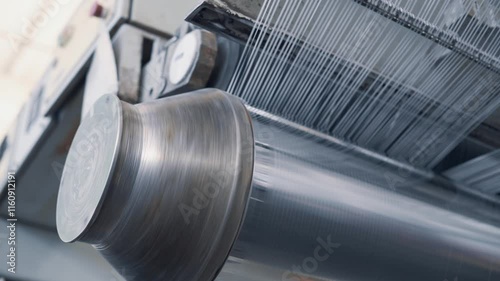 Operation of a flat-slot extruder in the production of polypropylene bags.