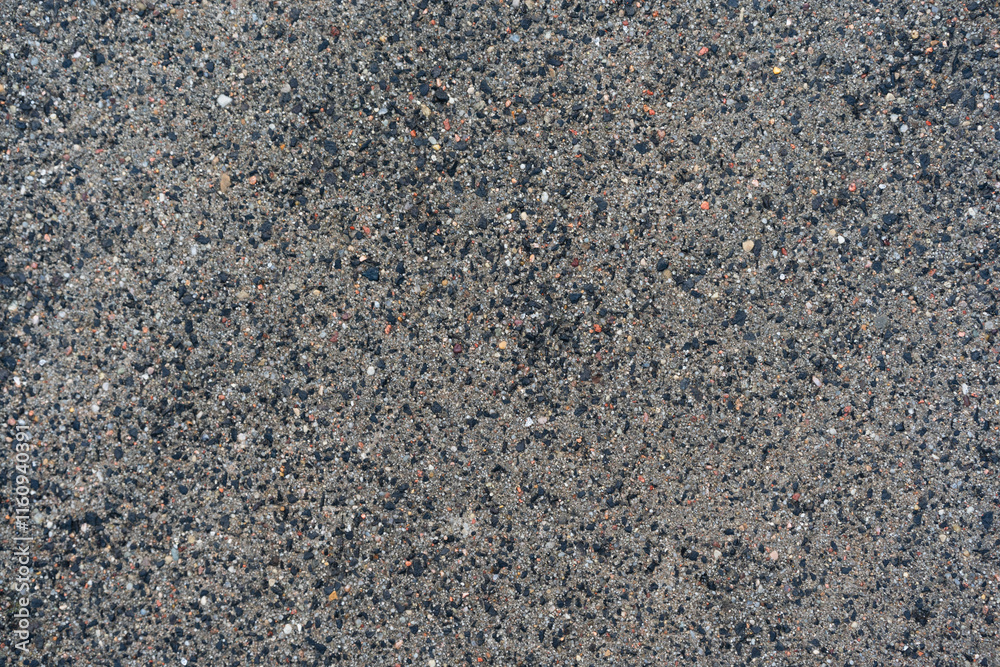 New asphalt texture. A frame filled with the textured surface of dry asphalt, showcasing the detailed pattern New asphalt texture. A frame filled with the textured surface of dry asphalt, showcasing the detailed pattern