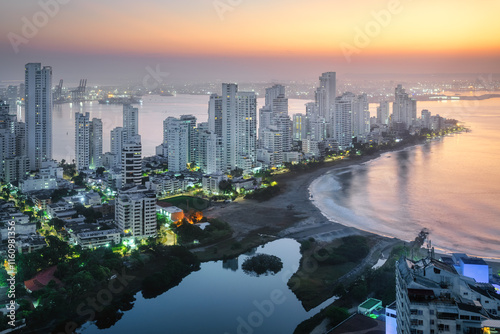 Modern skyscrapers in Cartagena city surrounded by the Caribbean sea on sunrise, Colombia photo