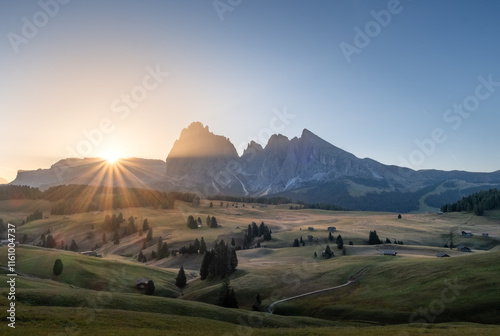 Fotografie Sunrise over the Seiser Alm alpine meadows with the Dolomites mountain peaks in