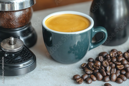 Coffee culture celebrates artisan brewing. Coffee cup with beans and grinder on a table. photo