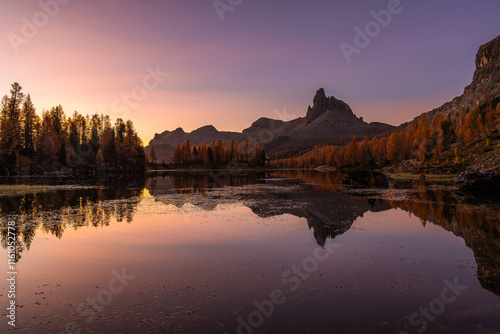 Lago Federa at golden hour during a cold day of October with golden larches reaching their peak of Fall colors