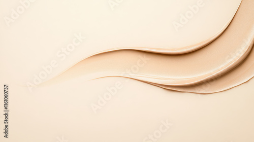 Liquid foundation smudges on a beige background close-up