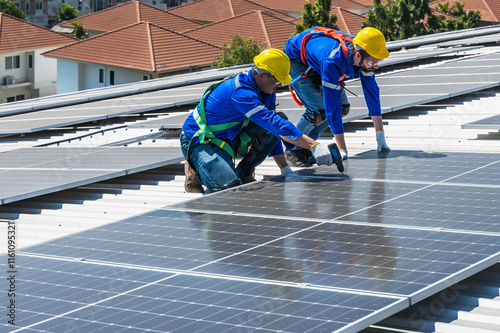 Wallpaper Mural Solar engineer men working with solar panels on roof Torontodigital.ca