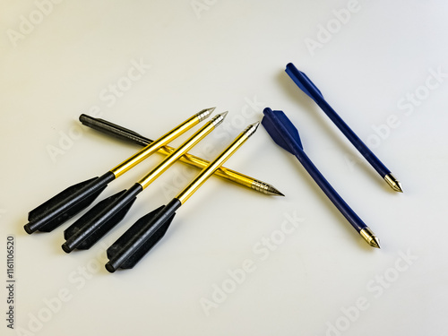 Arrows for a training crossbow on a white background. They are located chaotically.