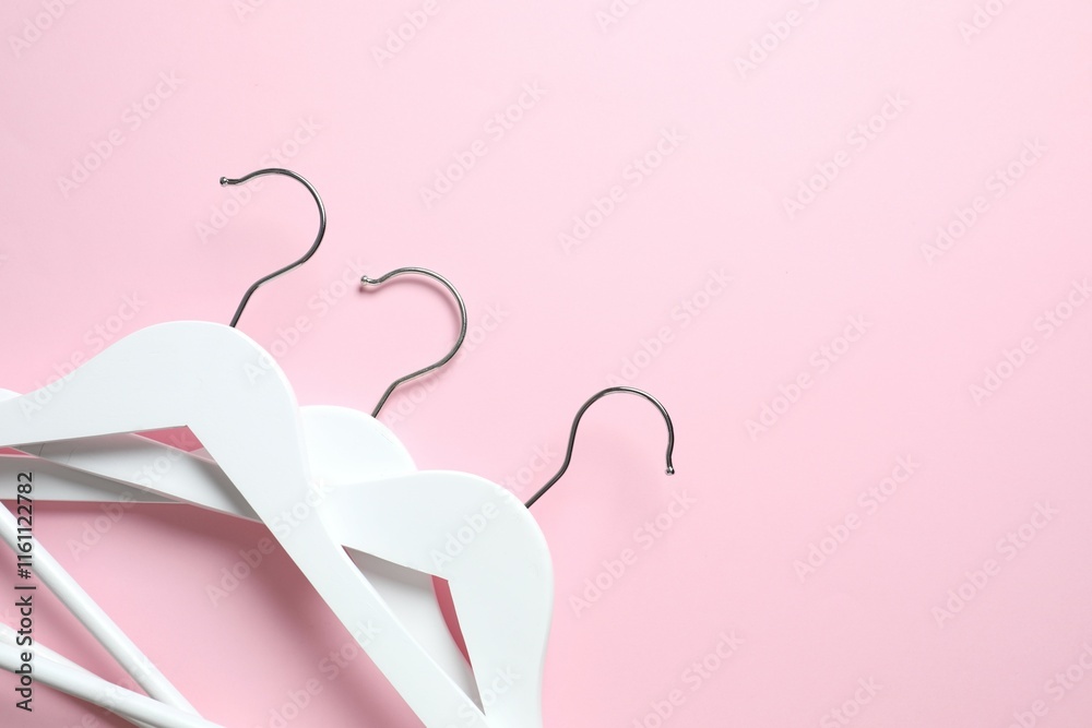 Wooden clothes hangers on a colored background Wooden clothes hangers on a colored background