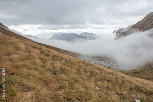 Landscape view of Fisht-Oshten massif in autumn covered with thick fog on a cloudy day, Adygea, Russian Federation photo