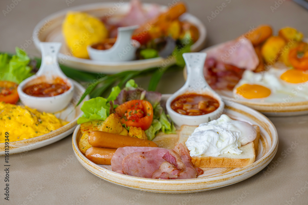 Breakfast with fried eggs and bacon and sausage. Breakfast set at hotel. Hearty Traditional Breakfast Plate with Eggs, Sausage, Bacon, Toast, and Vegetable Salad. Breakfast with fried eggs and bacon and sausage. Breakfast set at hotel. Hearty Traditional Breakfast Plate with Eggs, Sausage, Bacon, Toast, and Vegetable Salad.