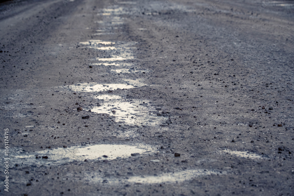gravel road, puddles on road, bad condition gravel road, puddles on road, bad condition