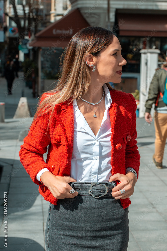 Fototapeta premium A stylish woman adorned with layered gold and diamond jewelry, including necklaces, bracelets, rings.