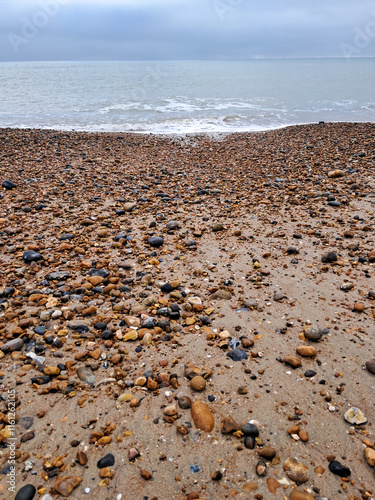 Pebble and sandy beach along the coast in Hove, Sussex photo