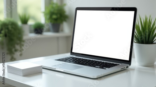 A laptop with a blank screen sits on a white desk surrounded by green potted plants and notebooks, creating a serene workspace by the window