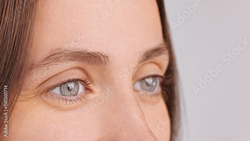 Laser eye surgery. Extreme close up macro shot of eyes female millennial looking away, advertising contact lens ophthalmology clinic services procedure for good vision. Focus on right eye model face photo