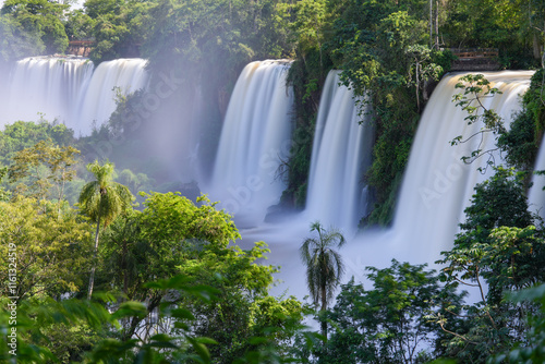 scenic landscape of waterfalls falling into the riverbed in the middle of the paradisiacal tropical jungle photo