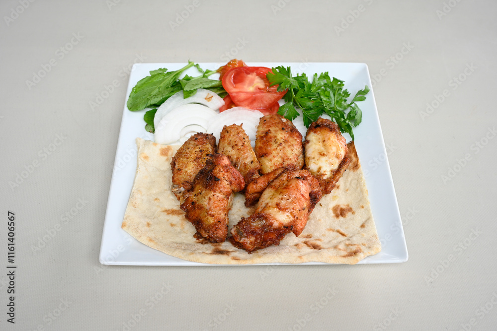 Fototapeta premium Chicken wings barbeque in a dish with BBQ grill sauce . Izgara tavuk kelebek sis kanat. Tavuk sis, gogus.