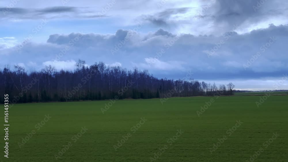 Town train road trip side window with a beautiful landscape. Nature green hills and forest before sunset. Travel from the train. Time lapse scene. Window replacement for car driving on roads. Town train road trip side window with a beautiful landscape. Nature green hills and forest before sunset. Travel from the train. Time lapse scene. Window replacement for car driving on roads.
