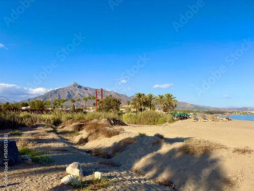 view from the beach to the Río Verde and the Puente de Puerto Banús bridge with a view towards the Pico de la Concha mountain, landmark of Marbella, Malaga, Costa del Sol, Spain photo