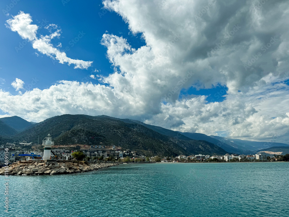 Fototapeta premium Scenic coastal view featuring a lighthouse under a dynamic sky in Cyprus