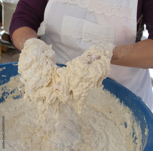 manos amasando harina agua sal buñuelos photo