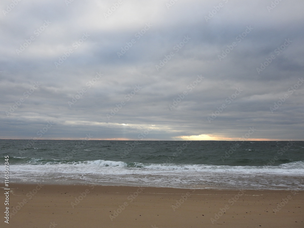 A beautiful sunset over the Atlantic Ocean, during the winter season. Cape Cod National Seashore, Massachusetts. A beautiful sunset over the Atlantic Ocean, during the winter season. Cape Cod National Seashore, Massachusetts.