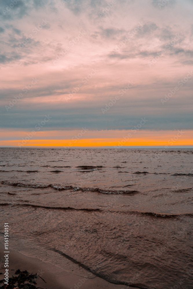 Obraz premium evening sunset by the sea with waves in the sea