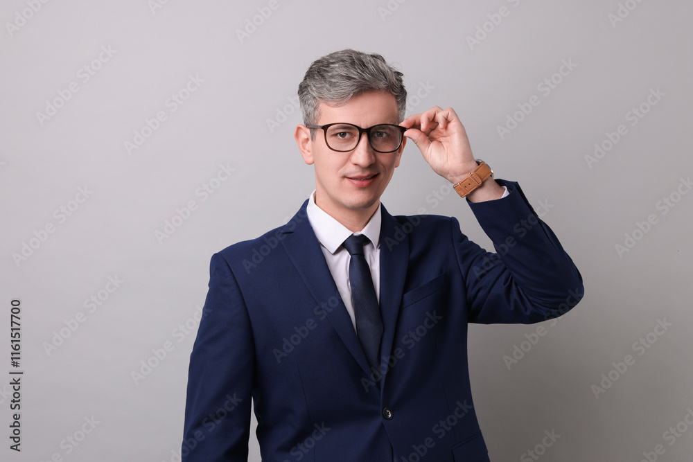 Portrait of businessman in glasses on light grey background Portrait of businessman in glasses on light grey background